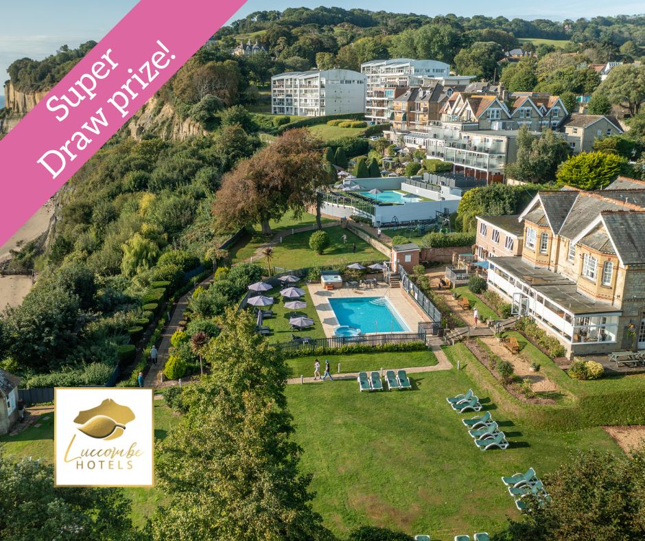 a picture of a cliff top hotel with swimming pools and green lawns